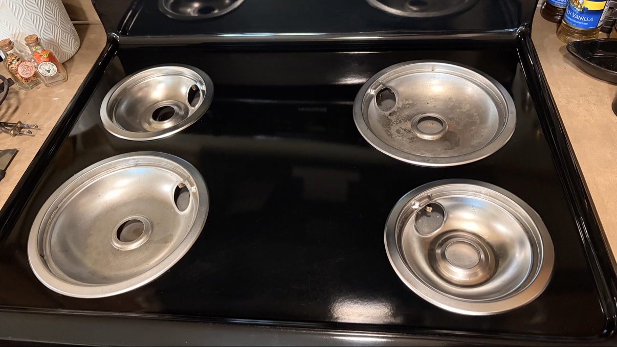 Shiny clean stovetop drip pans after cleaning